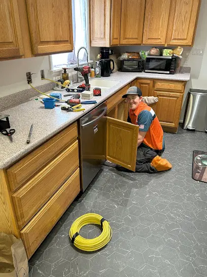 A leaking appliance supply line under a sink in Olympia, WA